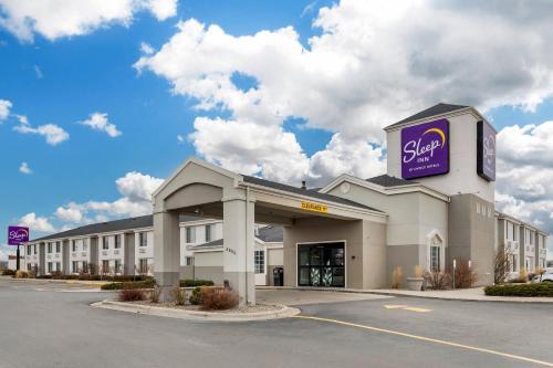 a large building with a sign on top of it at Sleep Inn Billings in Billings