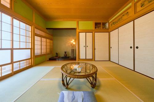 a room with a table in the middle of a room at 一棟貸切宿 空と家 in Tadotsu