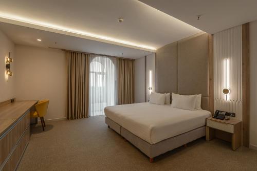 a hotel room with a bed and a television at Apart Hotel Istaravshan in Tashkent