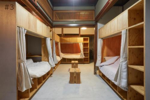 a room with two bunk beds and a chair at kitanUOZU in Uozu