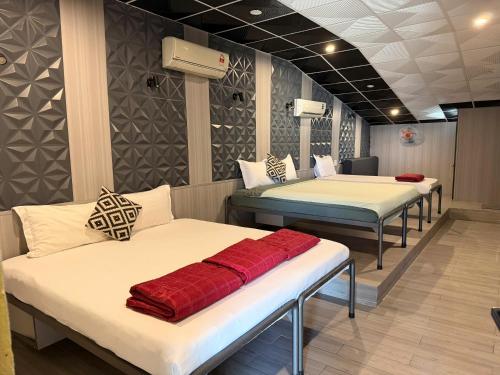 a room with three beds in a room with at Lynk Stay Hoian in Hoi An