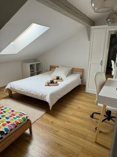 a bedroom with a large bed and a desk at Apartament Ana in Şelimbăr