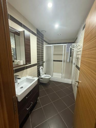 a bathroom with a sink and a toilet and a shower at Nur Sena's House in Istanbul