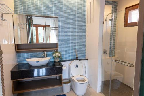a bathroom with a toilet and a sink and a shower at Premium Villa Baan Kinlom Chomlay in Hua Hin