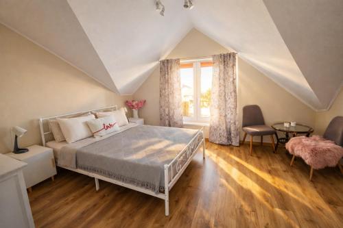 a bedroom with a large bed and a window at Family Hotel Daugavpils in Daugavpils