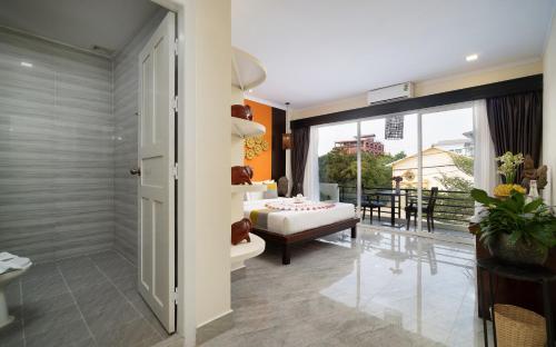 a bathroom with a room with a couch and a window at Indochine Sanctuary Boutique in Siem Reap