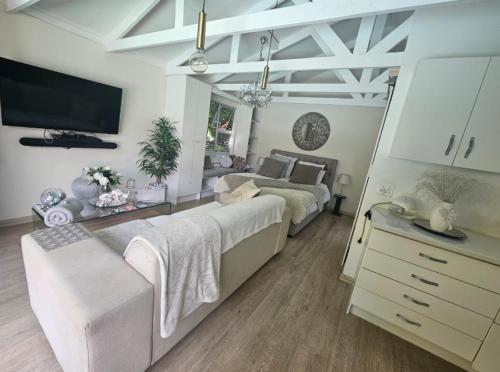 a bedroom with two beds and a television in it at African Diamond - Date Night Suite in Benoni