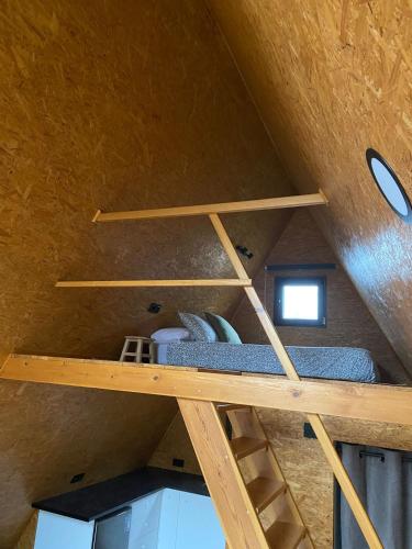 a bunk bed in a room in a house at El Roble Glamping - Cabaña Alpina Familiar in Lagunilla