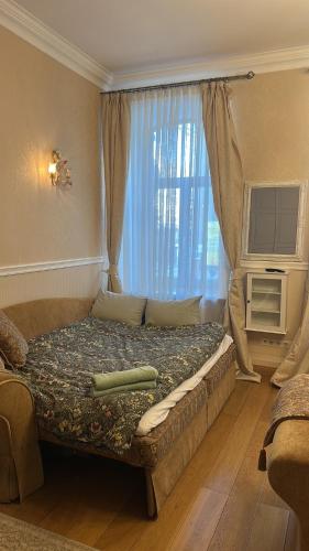 a large bed in a room with a window at classic in Daugavpils