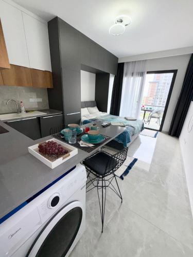 a kitchen with a table and a bed in a room at Riverside studio in Iskele in Dherinia