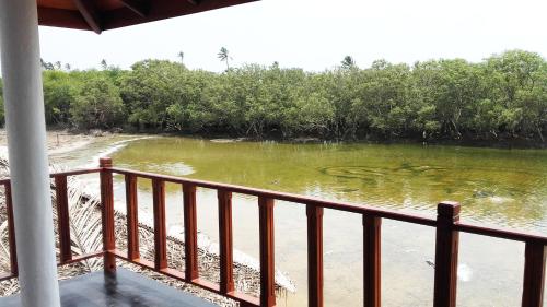 a view of a river from a balcony at Pearl Cave Cabanas & Resturant in Tangalle