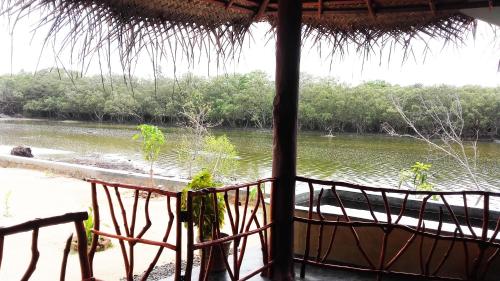 a view of a river from a straw hut at Pearl Cave Cabanas & Resturant in Tangalle