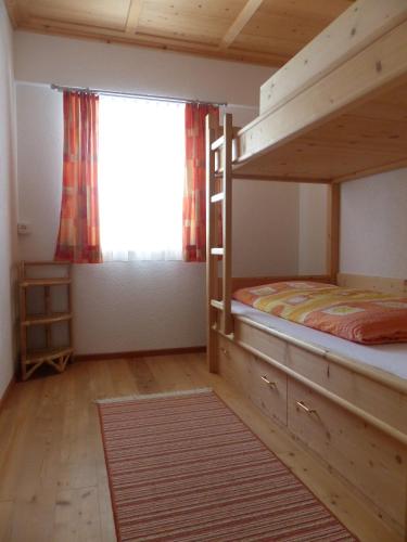 a bedroom with two bunk beds and a window at Ferienwohnung Innerlipper in Innervillgraten