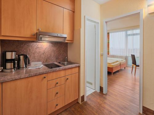 a kitchen with a sink and a counter top at Appartements im Freizeitpark Weissenhaeuser Strand in Weissenhäuser Strand