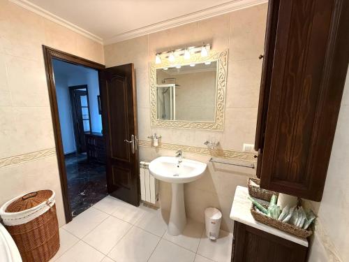 a bathroom with a sink and a mirror at A CALZADA in Cambados