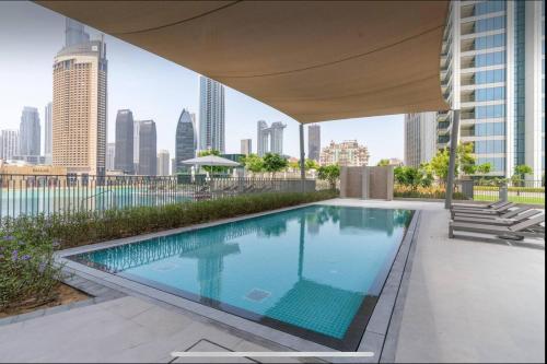 a swimming pool on the roof of a building at Private Room in Luxury Burj Vista Apartment Downtown with Burj Khalifa View in Dubai