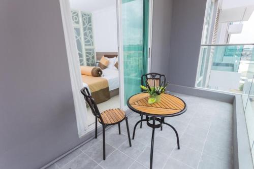 a room with a table and two chairs and a bed at CA&SA Serviced Apartment in Phnom Penh