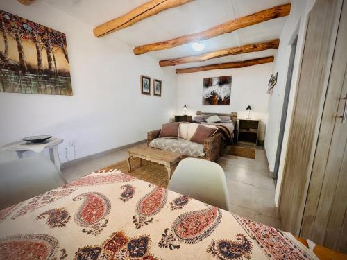 a living room with a bed and a table at Intimate Studio for Two at Hebron Estate in Piketberg