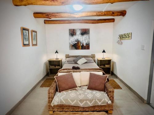 a bedroom with a bed and two night stands at Intimate Studio for Two at Hebron Estate in Piketberg