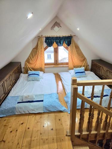 a bedroom with two beds in a attic at ApartPodhale in Raba Wyżna