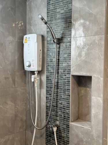 a shower in a bathroom with a shower at Msthouse in Ban Bang Phun