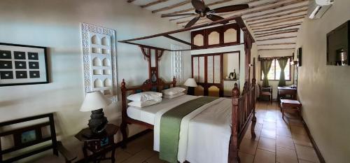 a bedroom with a large bed in a room at Baobab Sea Lodge in Kilifi
