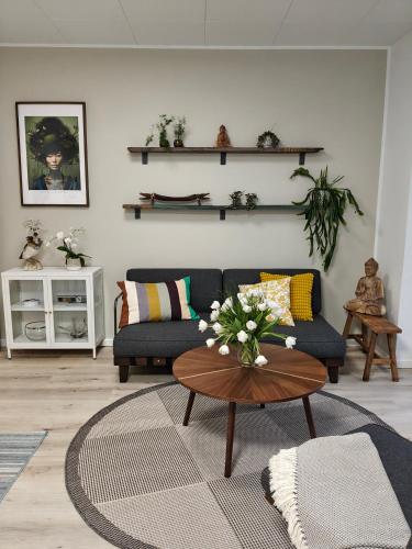 a living room with a couch and a table at Eksklusiv villalejlighed m/ have in Holme