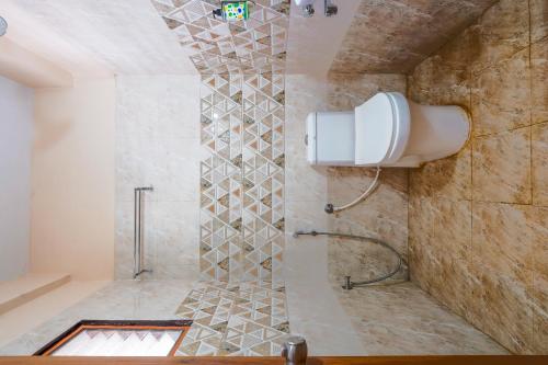 a bathroom with a shower with a glass door at Hotel Ocean View, Rushikonda Beach in Visakhapatnam