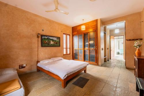 a bedroom with a bed and a couch at Elite Villa - By Purvish Hospitalities in Bangalore
