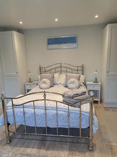 a bedroom with a bed and two night stands at Bow Cottage in Bridport