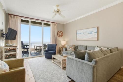 a living room with a couch and a tv at Spanish Key 209 in Perdido Key