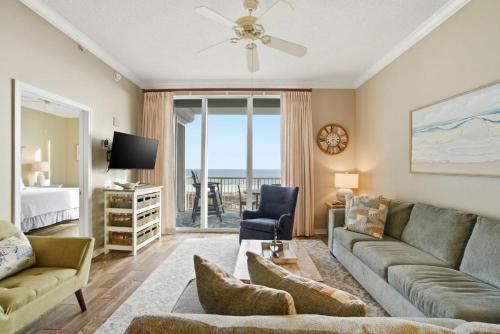 a living room with a couch and a tv at Spanish Key 209 in Perdido Key