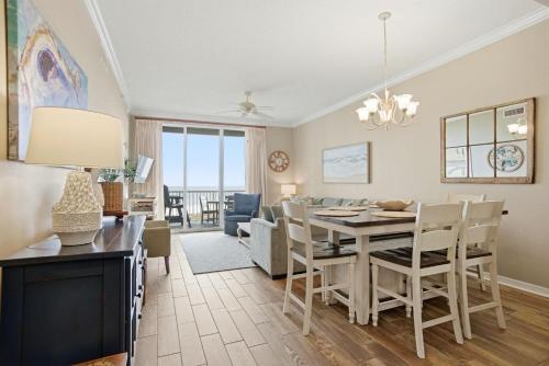 a dining room and living room with a table and chairs at Spanish Key 209 in Perdido Key
