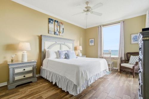 a bedroom with a bed and a window with the ocean at Spanish Key 209 in Perdido Key