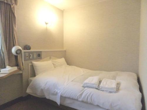 Ένα ή περισσότερα κρεβάτια σε δωμάτιο στο Hotel Nobeoka Hills