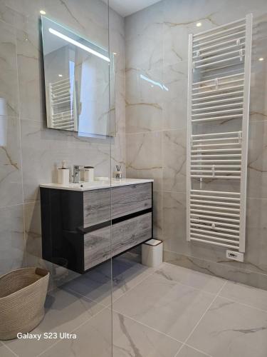 a bathroom with a sink and a mirror at Relax & work à Frespech 3 chambres 6 personnes in Frespech
