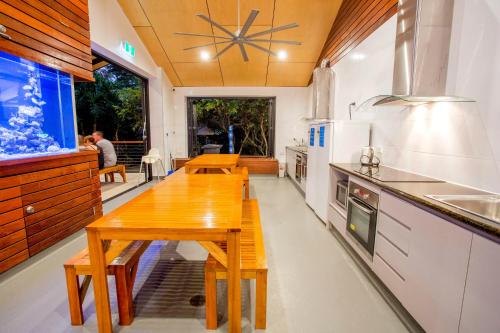 a kitchen with a wooden table and a large window at BIG4 Gold Coast Holiday Park in Gold Coast