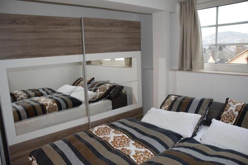 a bedroom with two beds and a mirror at Ferienwohnung Janssen Herborn in Herborn