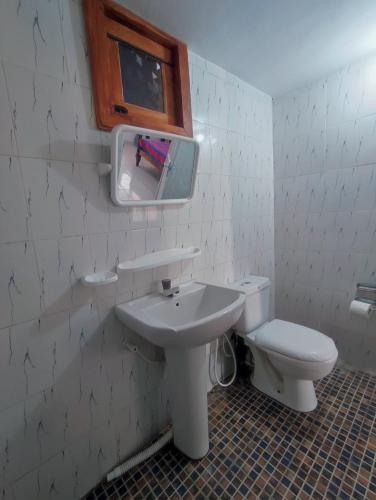 a bathroom with a sink and a toilet at Vino lanka in Trincomalee