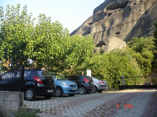 a group of cars parked in a parking lot at Guesthouse Papastathis in Kalabaka