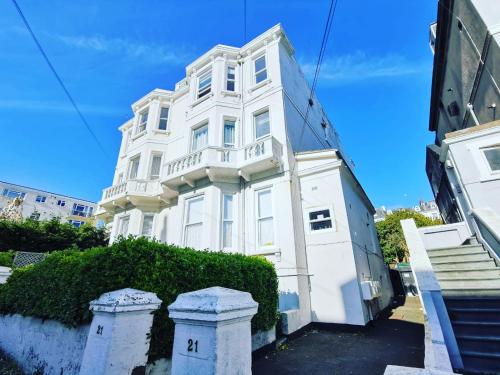 a white building with a balcony on it at The Retreat Magnificent Sea Side Apartment in Hastings