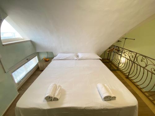 a bedroom with a bed with two towels on it at Corso Suite Gallipoli in Gallipoli