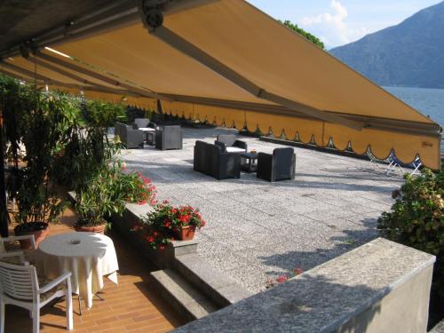 a large tent with tables and chairs and a lake at Albergo Del Lago in Cannobio
