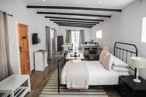 a bedroom with a bed and a living room at Modern Farm in Lichtenburg