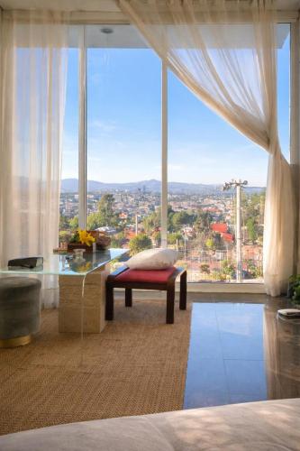 a bedroom with a large window with a view of a city at Amazing View From Los Fuertes in Puebla