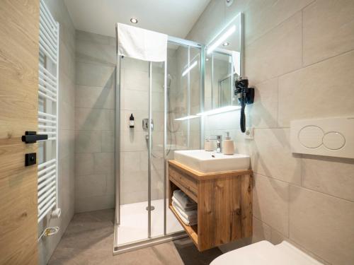 a bathroom with a sink and a shower at Pension Kohler in Fügen