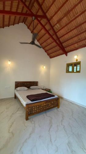 a bedroom with a large bed in a room at Taniva Dani by CoffeeBeanVilla in Sakleshpur