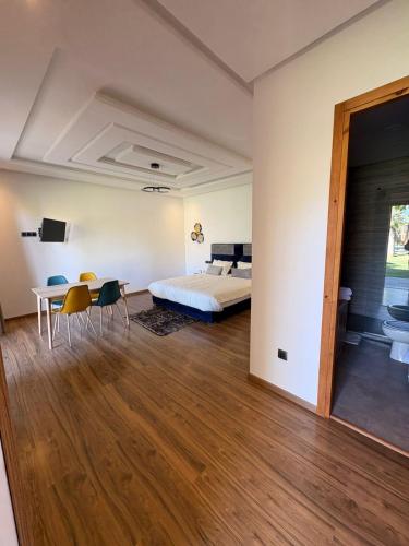 a bedroom with a bed and a table and chairs at Villa Sofia And Spa in Marrakesh