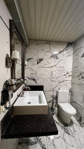 a bathroom with a sink and a toilet at Samsun Airport Resort Hotel in Samsun