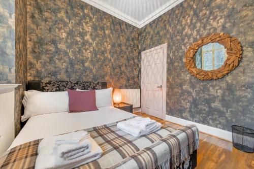 a bedroom with a bed and a mirror on the wall at The Old School in Dean Village in Edinburgh